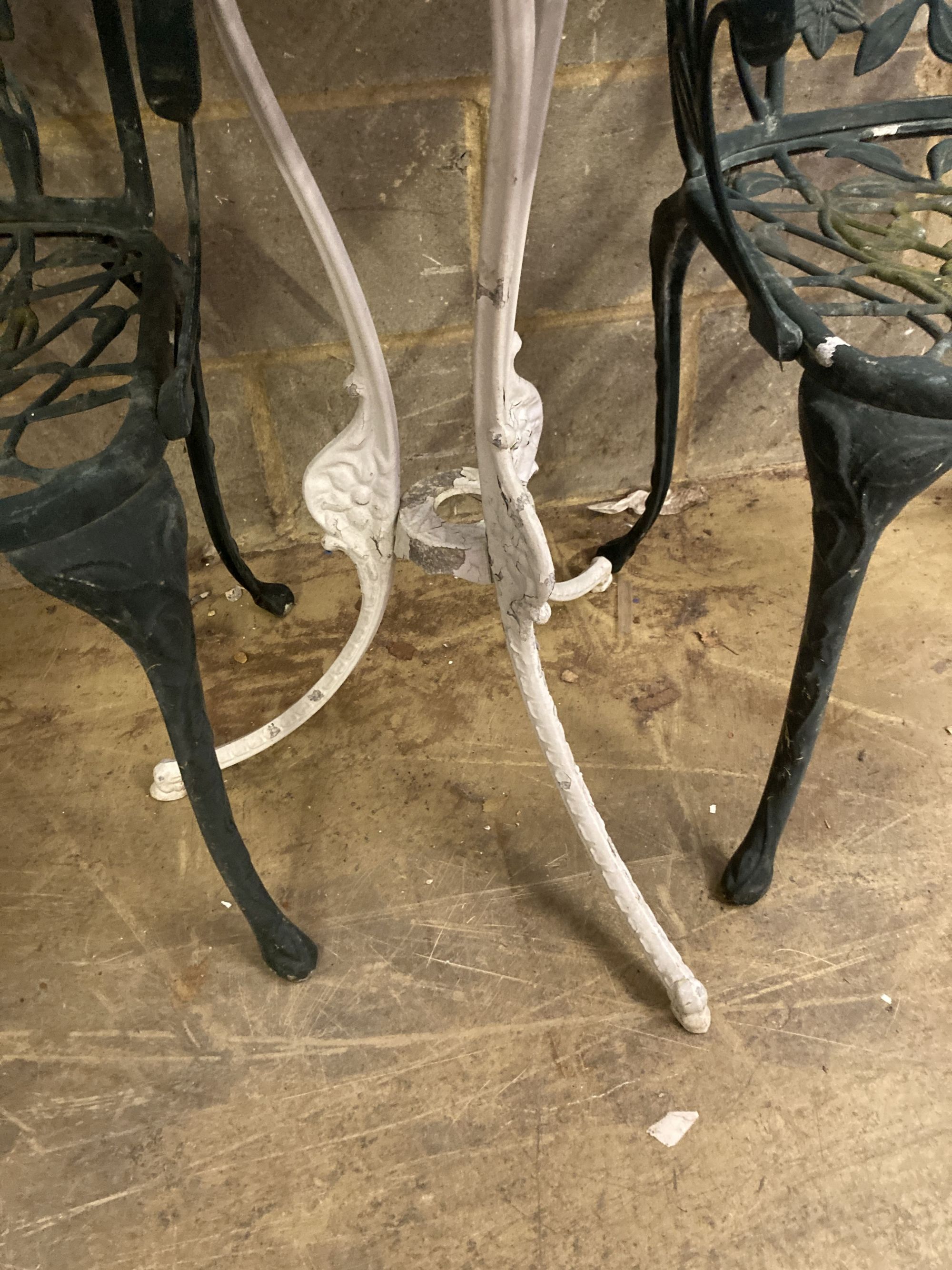 A Victorian style painted aluminium circular garden table, 69cm diameter together with a set of four garden elbow chairs